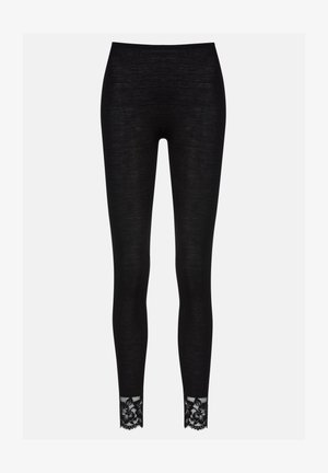 Zwarte legging gemaakt van ribbelstof, met een kantafwerking bij de enkel, wat textuur en detail toevoegt aan het stijlvolle ontwerp.