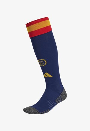 Calcetín de fútbol navy con puño a rayas rojas y amarillas, plantilla texturizada gris, marca amarilla y diseño acanalado para un mejor agarre.