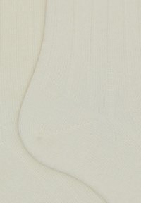 Calzini bianchi a coste con una texture morbida, caratterizzati da una punta senza cuciture e un motivo a maglia leggero e traspirante.