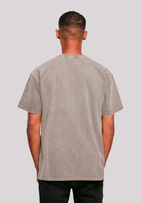 Gray short-sleeve t-shirt with a relaxed fit, featuring a crew neckline and subtle texture. Back view shows clean stitching and no logos.