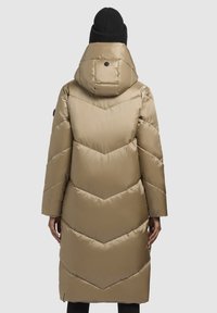 Long, puffer coat in metallic beige with chevron quilted pattern, hood, and black knit beanie, designed for warmth and coverage.
