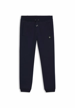Dunkelblaue Sweatpants aus weichem Material. Merkmale sind ein elastischer Bund mit Kordelzug, Seitentaschen und ein Logo-Patch am Oberschenkel.