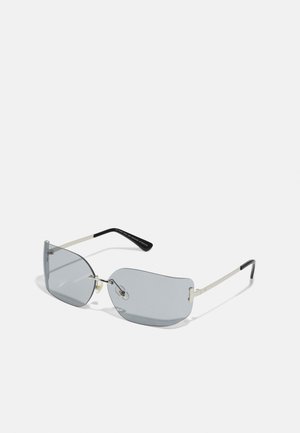 Silver metal-framed sunglasses with light gray tinted lenses, featuring an angular design and slender black temple arms.