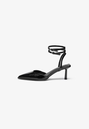 Black leather high-heeled shoe with a pointed toe and ankle strap. Features a sleek design and a slender 5 cm heel. Smooth texture.