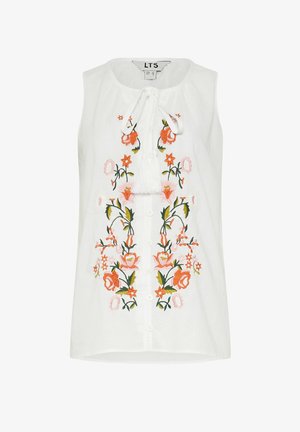 Blouse blanche sans manches avec des boutons sur le devant, des pampilles à nouer au col et une broderie florale symétrique orange et rose sur le devant.