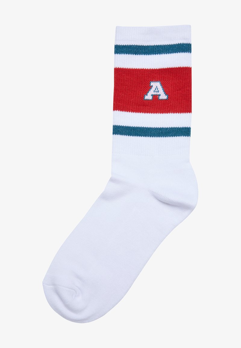 Fehér pamut keverék zokni, piros és türkiz csíkokkal, a felső részen egy kiemelkedő kék "A" logóval. Simább tapintás.