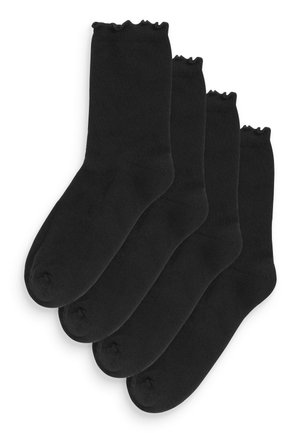 Lot de quatre paires de chaussettes en coton noir, avec un design haut de genou, une texture lisse et un bord ondulé en haut.