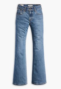 Ljust blå denim flare-jeans med fem fickor, knappstängning, synlig sömnad och trasiga fållar vid benen.