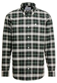 Vihreä-valkoinen ruudullinen napillinen paita, valmistettu puuvillasta. Siinä on tavallinen kaulus, pitkät hihat ja rintatasku, jossa on logo.