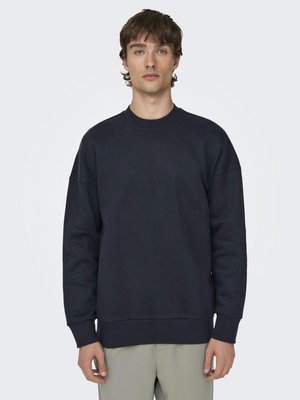 Sweatshirt bleu marine à coupe décontractée, avec des manches longues, un col rond et des poignets et ourlets côtelés, fabriqué en doux matériau en coton.