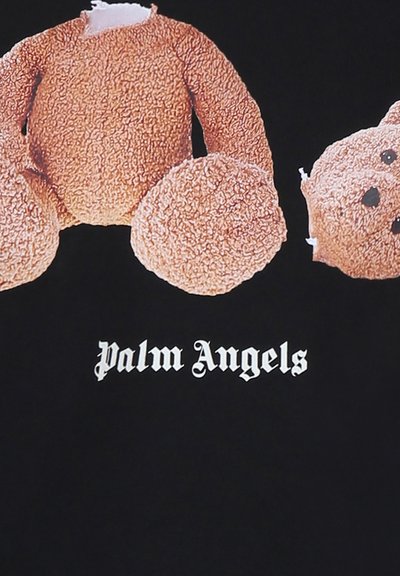 Tessuto nero con una grafica di un orsetto di peluche con un corpo marrone texturizzato e una toppa mancante, etichettato "Palm Angels" in font bianco.