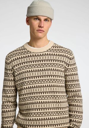 Maglione lavorato a maglia in crema e marrone, con un motivo geometrico, colletto rotondo e polsini a costine. Texture in misto cotone.