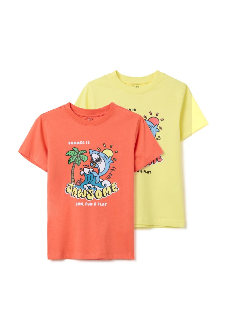 Dos camisetas de algodón: una de color coral con un diseño de un tiburón de dibujos animados y una palmera, la otra amarilla con gráficos similares, de mangas cortas y cuello redondo.