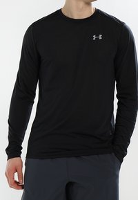 Black long-sleeve shirt made of lightweight fabric featuring a crew neck and a small silver logo on the upper left chest.