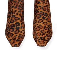 Leopard print ankle boots with square toes, made of soft fabric featuring a brown and black pattern. Smooth texture with a sleek design.
