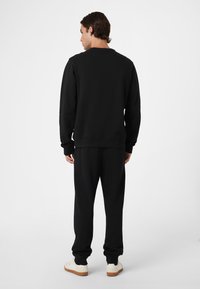 Fila BIELLA REGULAR - Verryttelyhousut - black