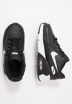 Czarno-białe buty sportowe Nike Air Max widoczne z góry i z boku, z widoczną amortyzacją powietrzną i sznurowanym designem na białym tle.