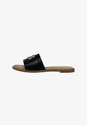 Black leather slide sandal with a wide strap, featuring a gold decorative accent. The sole is light brown cork with a textured finish.