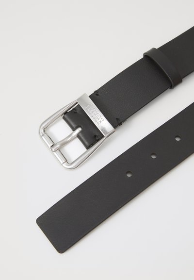 Black leather belt with a silver metal buckle and prong, featuring holes for adjustment. Smooth texture and rectangular shape.