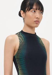 Black sleeveless bodysuit with a high neck, featuring a green and yellow wave pattern on the shoulders and sides. Smooth, stretchy fabric.