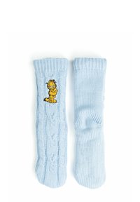 Calze blu lavorate a maglia con motivo a trecce e polsini a costine, decorate con un personaggio di cartone animato di un gatto giallo sul lato.