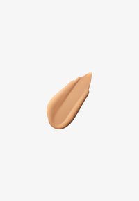 Creamy, smooth beige cosmetic product, shaped like a teardrop with a subtle sheen, resting on a white background.