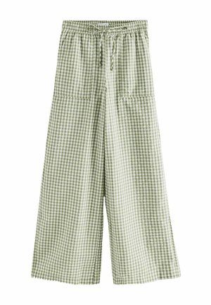 Pantalon large à carreaux verts et blancs avec taille élastique et cordon à l'avant, doté de deux grandes poches plaquées sur le devant.