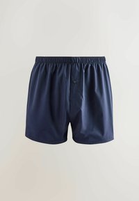 Navyblaue Boxershorts aus Baumwolle mit elastischem Bund und einer einzelnen Knopfleiste. Angenehme Textur und lockere Passform.