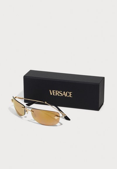 Versace prillid kuldse metallraamiga, pruuni varjundiga läätsed, mustad käepidemed ja logo küljel. Kaasas must kast kuldsete tähtedega.