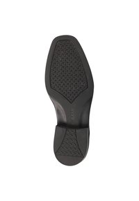 Semelle de chaussure en caoutchouc noir avec un motif texturé comportant une série de petits diamants en relief, conçue pour l'adhérence et la durabilité.