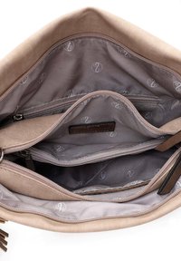 Beige fabric bag interior with multiple compartments, gray lining, and embossed logo pattern. Features a zipper and a leather label.