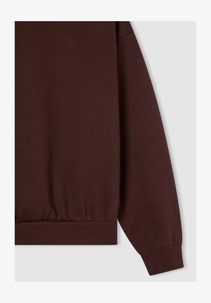 Felpa marrone con orlo e polsini a coste; tessuto morbido; presenta una vestibilità rilassata e un design con spalle scese.