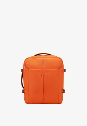Bright orange square-shaped travel bag with top handle, front zipper pocket, and side buckles for secure closure.