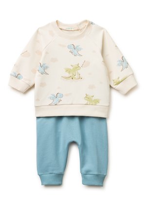Cremefarbenes Baby-Oberteil mit langen Ärmeln und blauen sowie grünen Drachenmotiven, kombiniert mit hellblauen, gerippten Hosen.
