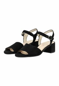 Sandalias de tacón bajo de ante negro con punta abierta, tiras en el tobillo y hebillas redondas plateadas, mostradas lado a lado sobre un fondo blanco.