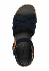 Mörkblå mockasandaler med korskorsade remmar, korkfotbädd och cirkulär vävd accent. Slät svart innersula och naturlig korkyttersula.