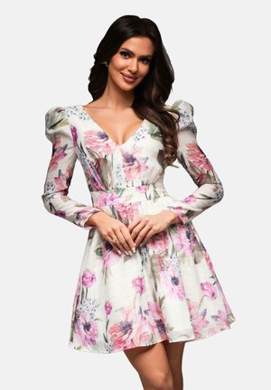 Floral dress featuring a V-neckline, long sleeves, and puffed shoulders. Made of lightweight fabric with a mix of pink and purple flowers.
