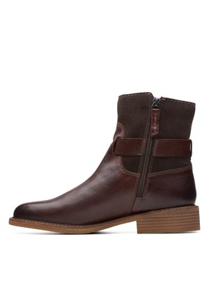Brown leather and suede ankle boot with side zipper, strap detail, and low wooden stacked heel.
