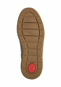 Shoe sole featuring a rubber material, tan color, textured surface with patterned grip, and a round red accent stating "COMFORT."