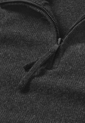 Black zip-up sweater made from soft, textured fabric with a partial zipper at the neckline and visible stitching details.