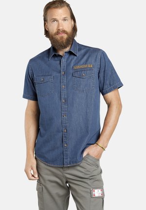 Short-sleeve denim shirt in a medium blue shade, featuring two chest pockets and a yellow embroidered logo on the left side.