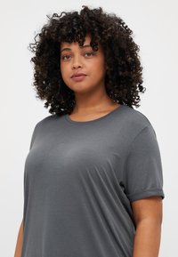 Gray short-sleeve t-shirt made of soft fabric, featuring a relaxed fit and round neckline, with rolled sleeves and smooth texture.