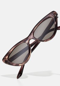 Brown tortoiseshell sunglasses with a cat-eye shape, featuring gray lenses and shiny, smooth acetate frames.