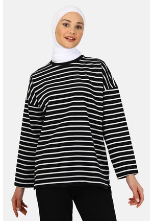 Black and white striped long-sleeve shirt with a relaxed fit, round neckline, and soft fabric texture. No visible patterns or hardware details.