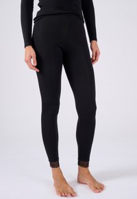 Leggings neri con una texture liscia e un design aderente. Il notevole orlo in pizzo alle caviglie aggiunge un tocco decorativo.