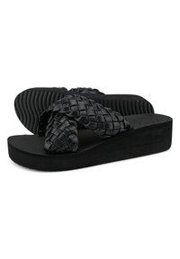 Black woven flip-flops with a chunky platform sole, textured footbed, and thick cross-strap design. Made of synthetic material. Flat bottom.