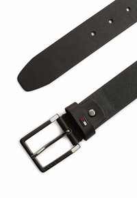 Ceinture en cuir marron avec une boucle en métal rectangulaire. Présente cinq trous pour les ajustements et un petit logo au design en couleurs près de la boucle.