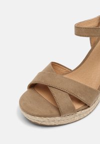 Braune Wildleder-Espadrilles mit Kreuzriemen, geflochtenem Jutemittelsohle und gepolsterter Innensohle; ausgestattet mit einer runden Zehenpartie und einem Knöchelriemen.