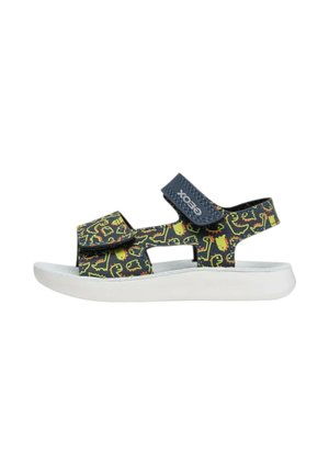 Sandalo blu navy per bambini con stampa gialla di dinosauro, due cinturini regolabili in velcro e suola bianca imbottita.