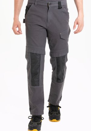 Pantalons de travail gris en tissu résistant avec panneaux en maille noire, plusieurs poches et coutures renforcées. Dotés d'une coupe regular et d'une taille ajustable.